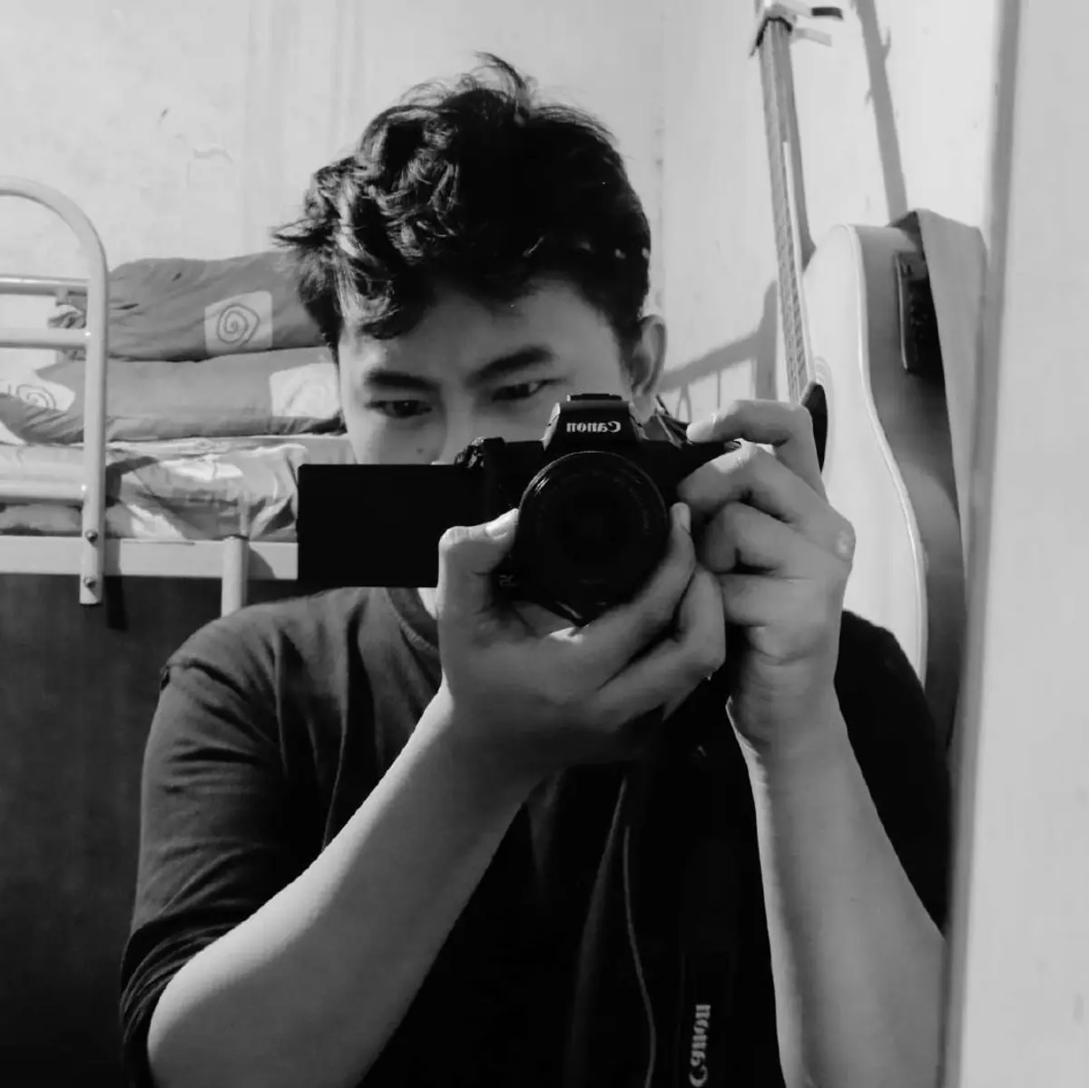 Rafi Alviar holding a camera to his eye